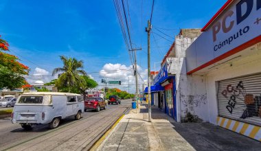 Playa del Carmen Quintana Roo Mexico 2021 Typical street road and cityscape with cars traffic restaurants shops stores people and buildings of Playa del Carmen in Quintana Roo Mexico.