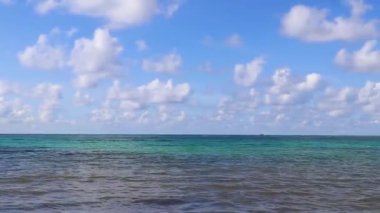 Tropical caribbean beach landscape panorama with clear turquoise blue water in Playa del Carmen Mexico.