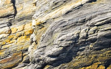 Beautiful rocks cliffs stones and boulders pattern and texture of the beach in La Punta Zicatela Puerto Escondido Oaxaca Mexico.