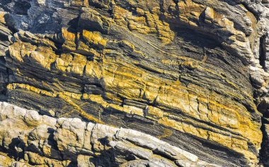 Beautiful rocks cliffs stones and boulders pattern and texture of the beach in La Punta Zicatela Puerto Escondido Oaxaca Mexico.