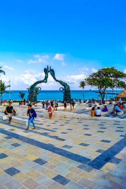 Playa del Carmen Quintana Roo Mexico 17. April 2021 The ancient architecture of the Portal Maya in the Fundadores park with blue sky and turquoise seascape and beach panorama in Playa del Carmen Quintana Roo Mexico.