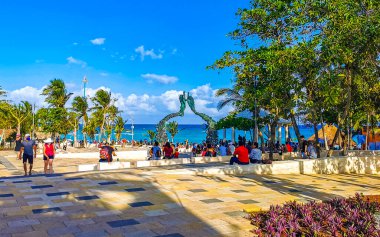 Playa del Carmen Quintana Roo Mexico 17. April 2021 The ancient architecture of the Portal Maya in the Fundadores park with blue sky and turquoise seascape and beach panorama in Playa del Carmen Quintana Roo Mexico.