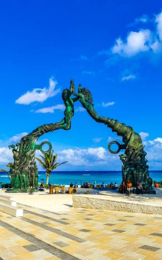 Playa del Carmen Quintana Roo Mexico 17. April 2021 The ancient architecture of the Portal Maya in the Fundadores park with blue sky and turquoise seascape and beach panorama in Playa del Carmen Quintana Roo Mexico.