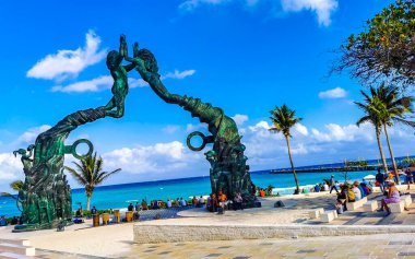 Playa del Carmen Quintana Roo Mexico 17. April 2021 The ancient architecture of the Portal Maya in the Fundadores park with blue sky and turquoise seascape and beach panorama in Playa del Carmen Quintana Roo Mexico.