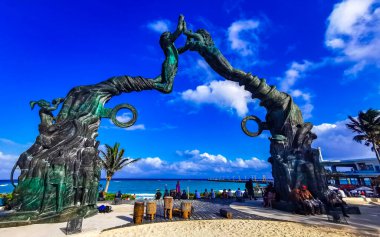 Playa del Carmen Quintana Roo Mexico 17. April 2021 The ancient architecture of the Portal Maya in the Fundadores park with blue sky and turquoise seascape and beach panorama in Playa del Carmen Quintana Roo Mexico.