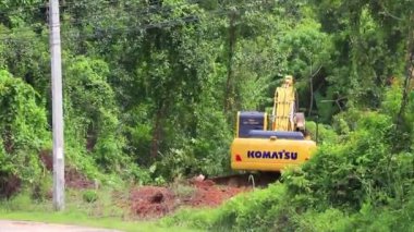 Thalang Phuket Thailand 14. October 2018 Big yellow excavator digs destroys forest jungle in Sakhu Thalang on Phuket island Thailand in Southeastasia Asia.