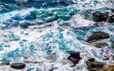 Beautiful rocks cliffs stones and boulders and huge big surfer waves and natural panorama view on the beach in Bacocho Puerto Escondido Oaxaca Mexico.