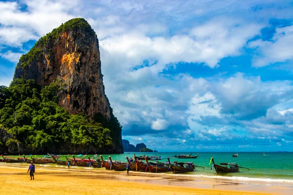 Longtail boat boats at the beautiful famous beach lagoon between limestone rocks and turquoise water on Railay West Beach in Ao Nang Amphoe Mueang Krabi Thailand in Southeast Asia.