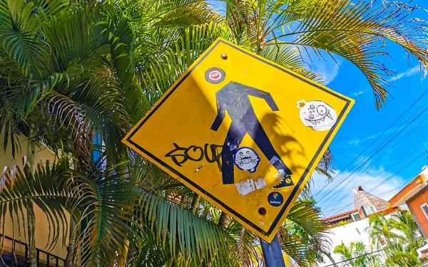 Yellow pedestrian sign street sign in Playa del Carmen Quintana Roo Mexico.
