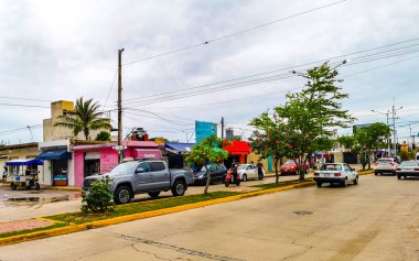 Playa del Carmen in Quintana Roo Mexico 15. June 2021 Typical street road and cityscape with cars traffic restaurants shops stores people and buildings of Playa del Carmen in Quintana Roo Mexico.