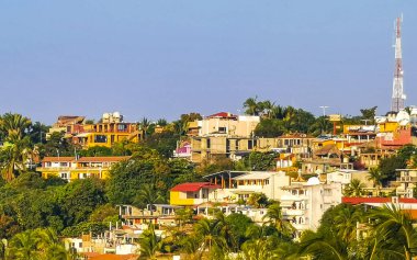 Beautiful tropical and natural city and seascape landscape panorama view with pacific ocean sea palms palm trees and beach with waves of Zicatela Puerto Escondido Oaxaca Mexico.