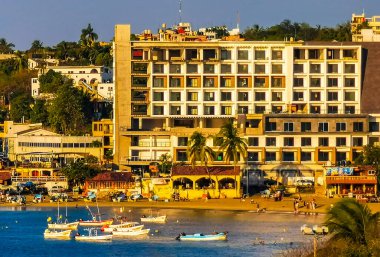 Beautiful tropical and natural city and seascape landscape panorama view with pacific ocean sea palms palm trees and beach with waves of Zicatela Puerto Escondido Oaxaca Mexico.