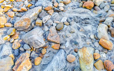 Beautiful rocks cliffs stones and boulders pattern and texture of the beach in La Punta Zicatela Puerto Escondido Oaxaca Mexico.