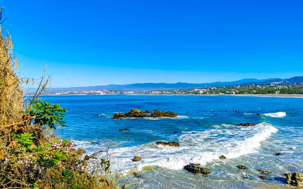 stock image Beautiful rocks cliffs stones and boulders and huge big surfer waves on the beach in La Punta Zicatela Puerto Escondido Oaxaca Mexico.