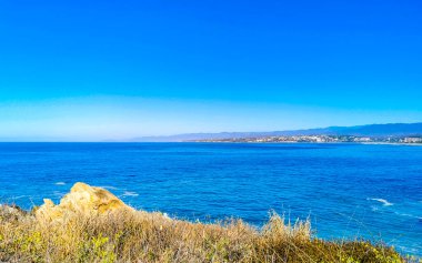 Beautiful tropical and natural city and seascape landscape panorama view with pacific ocean sea palms palm trees and beach with waves of Zicatela Puerto Escondido Oaxaca Mexico.