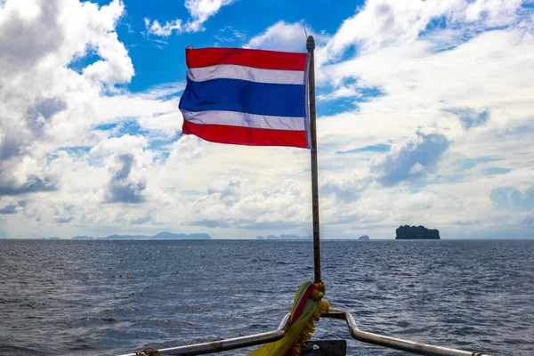Thailand thai flag on boat on tour in Phang Nga Bay Krabi Thailand in Southeast Asia.