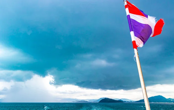 Thailand Thai flag on boat on tour in Ratsada Amphoe Mueang Phuket on Phuket island Thailand in Southeastasia Asia.