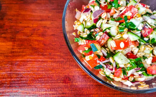 Stock image Mexican cuisine guacamole salad with tomatoes cucumbers avocado onions beans and garlic in Zicatela Puerto Escondido Oaxaca Mexico.