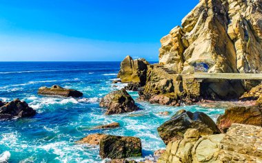 Mavi turkuaz su ve son derece güzel büyük sörfçü kayalıkları kayalar dağlar ve kayalar Zicatela Puerto Escondido Oaxaca 'daki plajlar.