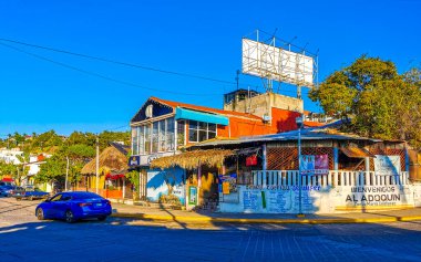 Puerto Escondido Oaxaca Meksika 16. Ocak 2023 Tipik güzel turist caddesi yolu ve şehir arabalarıyla kaldırım oteller, restoranlar ve Zicatela Mexico 'daki insanlar..