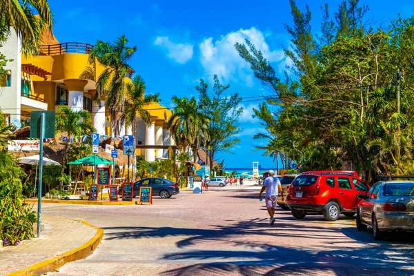 Playa del Carmen 26. March 2021 Typical street road and cityscape with cars traffic restaurants shops stores people and buildings of Playa del Carmen in Quintana Roo Mexico.