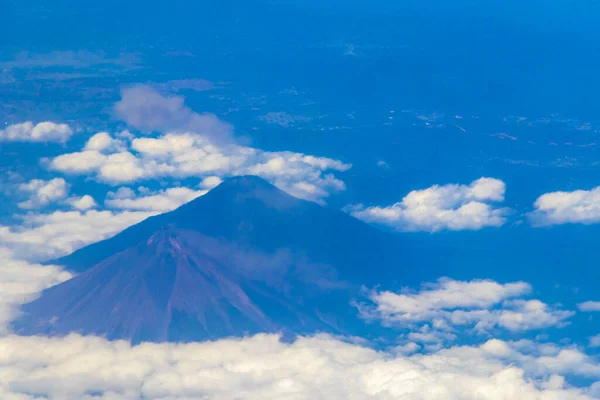 stock image Flying by plane over Mexico with view of volcanoes mountains and clouds.