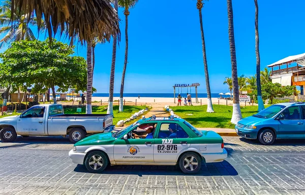 stock image Puerto Escondido Oaxaca Mexico 01. March 2023 Colorful green turquoise blue orange yellow gold or red taxi cab car in Zicatela Puerto Escondido Oaxaca Mexico.