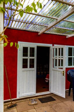 Green garden with beautiful red garden house in norwegian style in Leherheide Bremerhaven Bremen Germany.