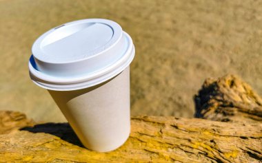 Kumsaldaki beyaz kupa El Cafecito 'ya gitmek için kahve. Kum denizi ve dalgalar Zicatela Puerto Escondido Oaxaca Meksika' nın tadını çıkarıyor..