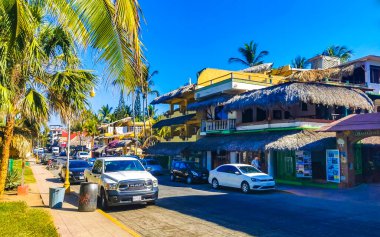 Puerto Escondido Oaxaca Meksika 24. Mart 2023 Tipik güzel turistik cadde yolu ve şehir arabalarıyla kaldırım oteller, restoranlar ve Zicatela Mexico 'daki insanlar..