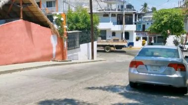Puerto Escondido Oaxaca Meksika 29. Mart 2023 Tipik güzel turistik cadde yolu ve şehir arabalarıyla kaldırım oteller, restoranlar ve Zicatela Mexico 'daki insanlar..