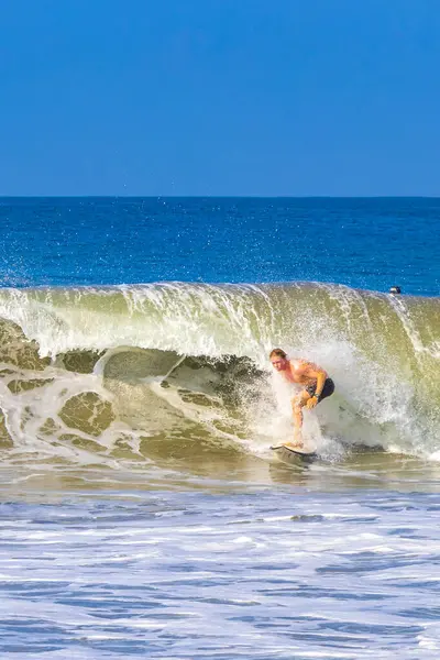 stock image Puerto Escondido Oaxaca Mexico 13. November 2022 Surfer surfing on surfboard on high waves on beautiful sunny beach with blue sky in Zicatela Puerto Escondido Oaxaca Mexico.