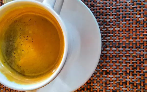 stock image Glass cup of americano black coffee with spoon and plate on table food and drink in the restaurant cafe in Playa del Carmen Quintana Roo Mexico.