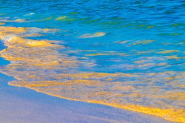 Dalgalar, Playa del Carmen Meksika 'daki tropik Meksika Karayip plajlarında mavi su ve kumsala vurur..