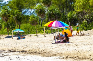 Playa del Carmen Quintana Roo Mexico 09. Eylül 2023 Tropikal Meksika Karayip plajı ve denizi çok eğlenceli insanlarla güneş şemsiyeleri Playa del Carmen Meksika 'da turkuaz su.