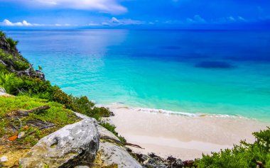 Natural seascape and beach panorama view at the ancient Tulum ruins Mayan site with temple ruins pyramids and artifacts in the tropical natural jungle forest palm in Tulum Mexico. clipart