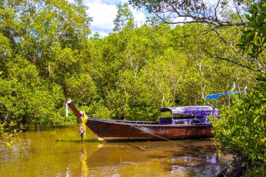 Beautiful tropical paradise panorama view on turquoise water beach with longtail boat boats and between limestone rocks on Ao Nang Beach in Amphoe Mueang Krabi Thailand in Southeast Asia.