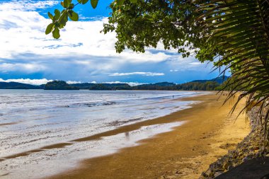 Beautiful tropical paradise panorama view on turquoise water beach and between limestone rocks cliffs mountains on Noppharat Thara Beach in Ao Nang Krabi Thailand. clipart