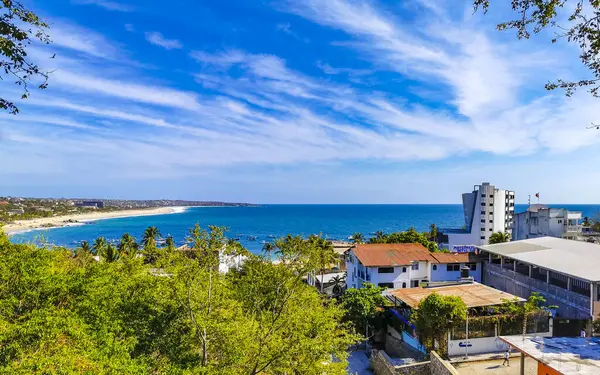 stock image Puerto Escondido Oaxaca Mexico 01. March 2023 Beautiful tropical and natural city and seascape landscape panorama view with pacific ocean sea palms palm trees and beach with waves of Zicatela.