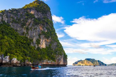 Uzun kuyruklu tekneler, Ao Nang Krabi Tayland 'daki Koh Phi Phi Leh adasındaki kireçtaşı kayaları ve turkuaz su arasındaki meşhur sahil gölünde..