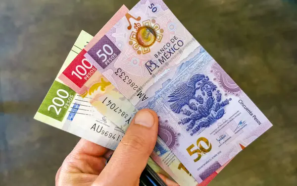 stock image Money Mexican peso bills in hand in Zicatela Puerto Escondido Oaxaca Mexico.