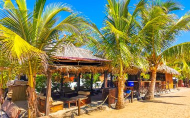 Restoran restoranlarının barları otellerde palmiye ağaçları ve Zicatela Puerto Escondido Oaxaca 'daki sahilde gezinti yerleri satıyor..