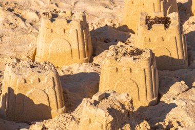 Castle castles made of white sand with buckets on the beach in Playa del Carmen Quintana Roo Mexico. clipart