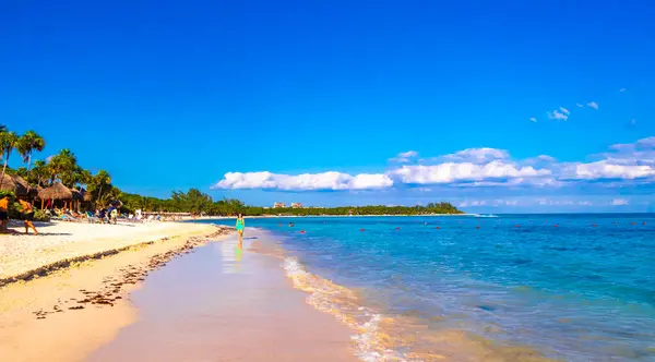 stock image Tropical mexican caribbean beach and sea with a lot of fun people sun loungers parasols turquoise palms water in Playa del Carmen Mexico.