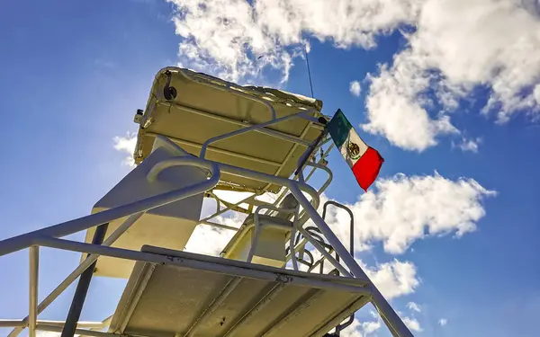 stock image Mexican flag on the shaking boat roof with blue sky on Isla Mujeres island in Cancun Quintana Roo Mexico.