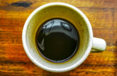 Playa del Carmen Quintana Roo Meksika 'daki restoran kafeteryasında bir tabak kaşık ve tabakla bir bardak koyu americano kahvesi..