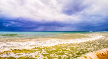 Playa del Carmen Meksika 'da berrak turkuvaz mavi su dalgaları ve kara bulutlarla şaşırtıcı tropikal Meksika Karayip plajı ve deniz manzarası manzarası..