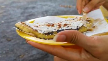 Mexican food tlakobananas tlakojos of banana dough with cheese beans spinach and hot sauce in Playa del Carmen Quintana Roo Mexico.