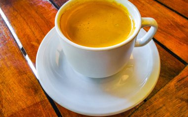 Playa del Carmen Quintana Roo Meksika 'daki restoran kafeteryasında bir tabak kaşık ve tabakla bir bardak koyu americano kahvesi..