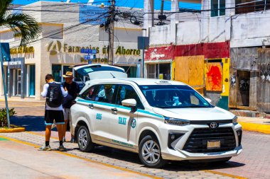 White turquoise taxi cab car cars vehicle taxis cabs in Playa del Carmen Quintana Roo Mexico. clipart